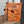 Lade das Bild in den Galerie-Viewer, Rucksack orange mit Fischmotiv und Bommeln vor einem Spiegel

