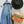 Lade das Bild in den Galerie-Viewer, Orange Cross Body Bag mit Bommeln hängt an der Garderobe

