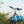 Load image into Gallery viewer, Die upcycelte Sporty Bag in blau hängt an einem Fahrradlenker.
